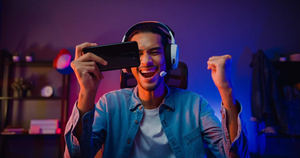 Happy,asia,man,gamer,wear,headphone,competition,play,video,game